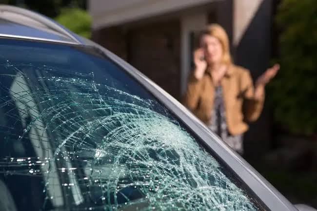 Car windshield shattered into a spiderweb of cracks